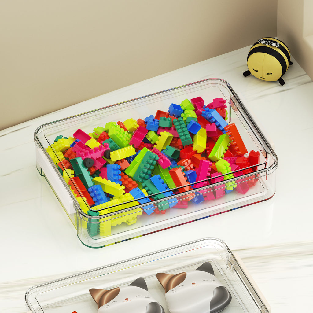 Shallow clear storage box filled with colorful building blocks